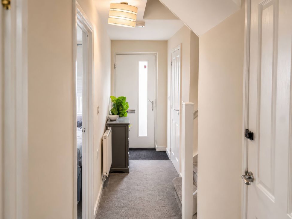 A hallway with a door and stairs at 4 Britannia Street Salford