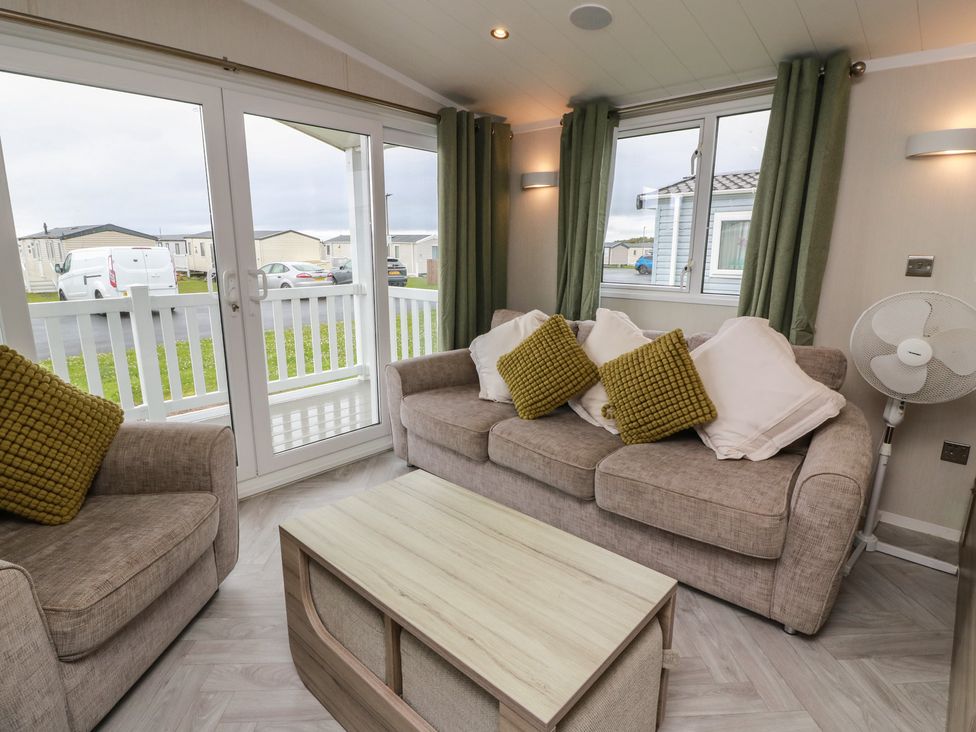 A living room with sofas and a coffee table at 101 Bay View Ayr