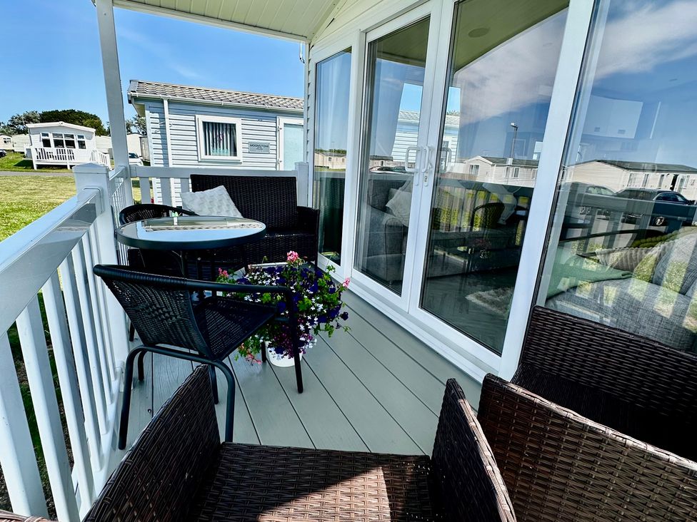 A balcony with a table and chairs at Craig Tara Holiday Park 101 Bay View, Ayr