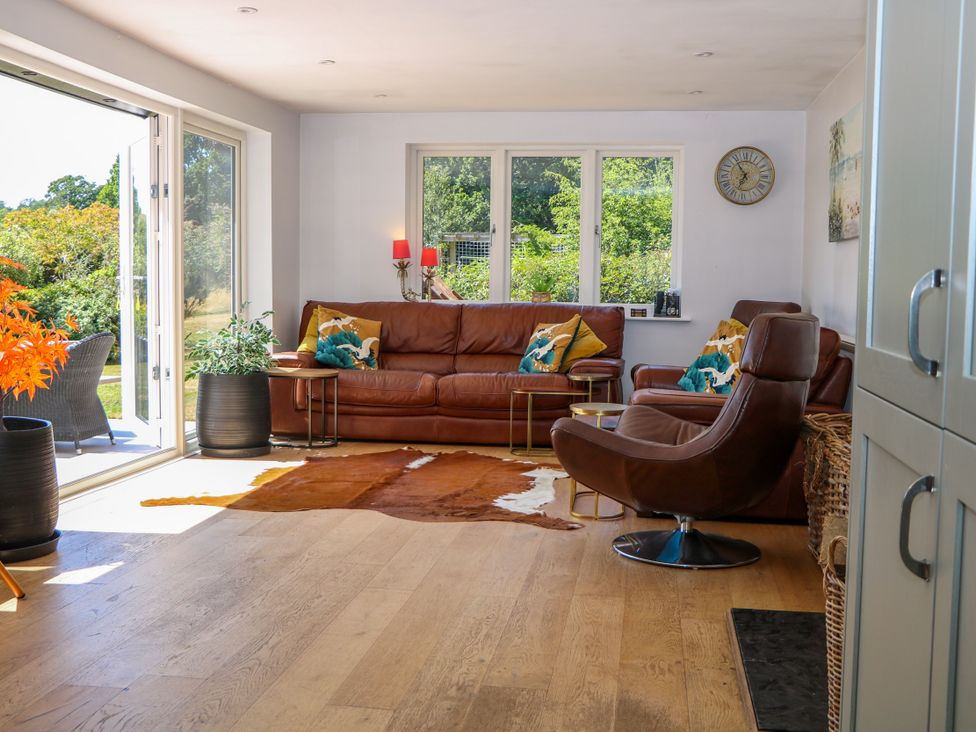 A living room with a sofa and armchair at Perry Dees in Minstead