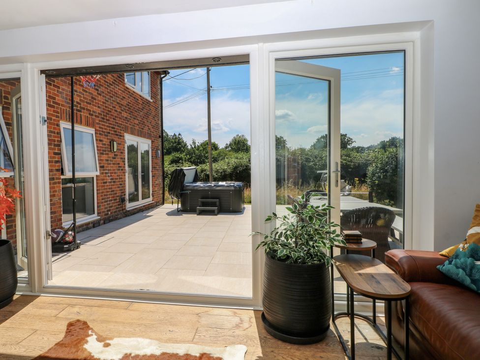 A seating area with sliding doors overlooking a patio at Perry Dees in Minstead