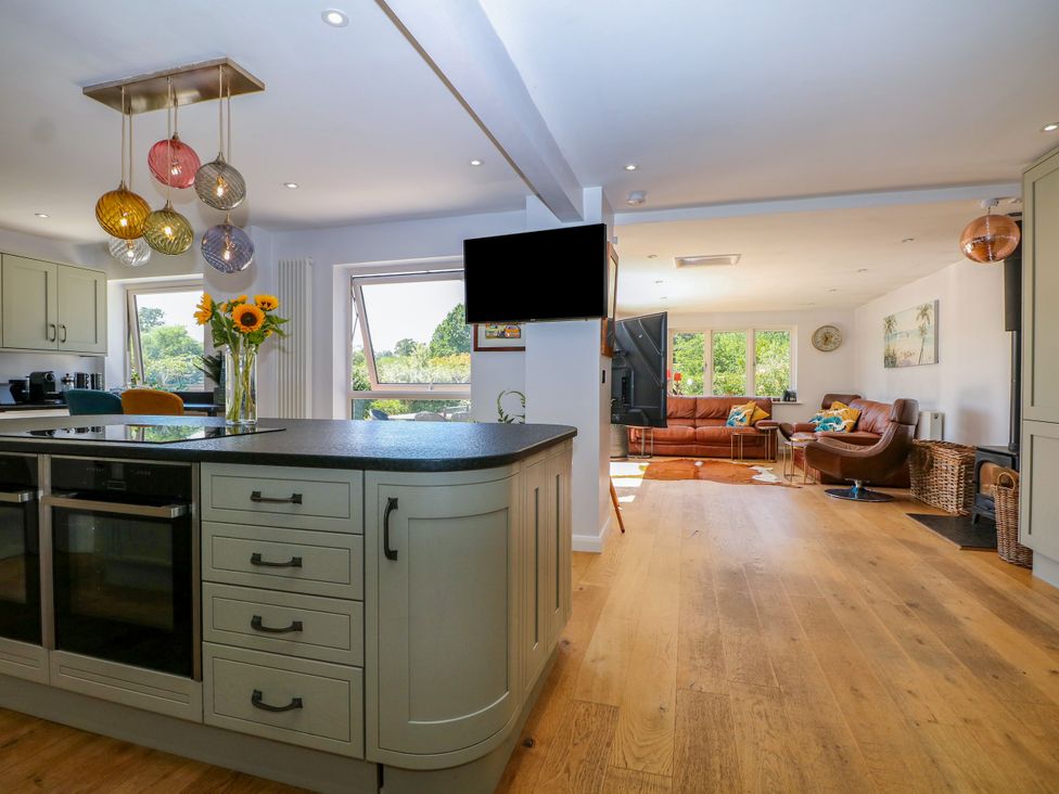 A kitchen with a kitchen island and sofa at Perry Dees in Minstead