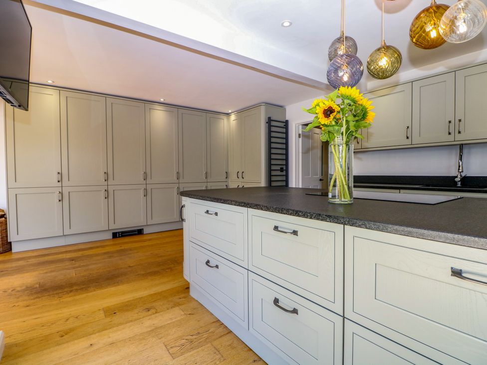 A kitchen with cabinets and an island at Perry Dees in Minstead