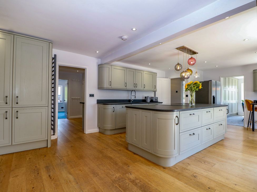 A kitchen with cabinets and an island at Perry Dees in Minstead