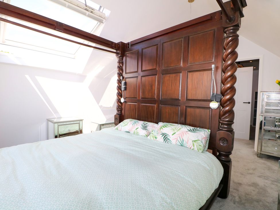 A bedroom with a bed and bedside table at Perry Dees in Minstead