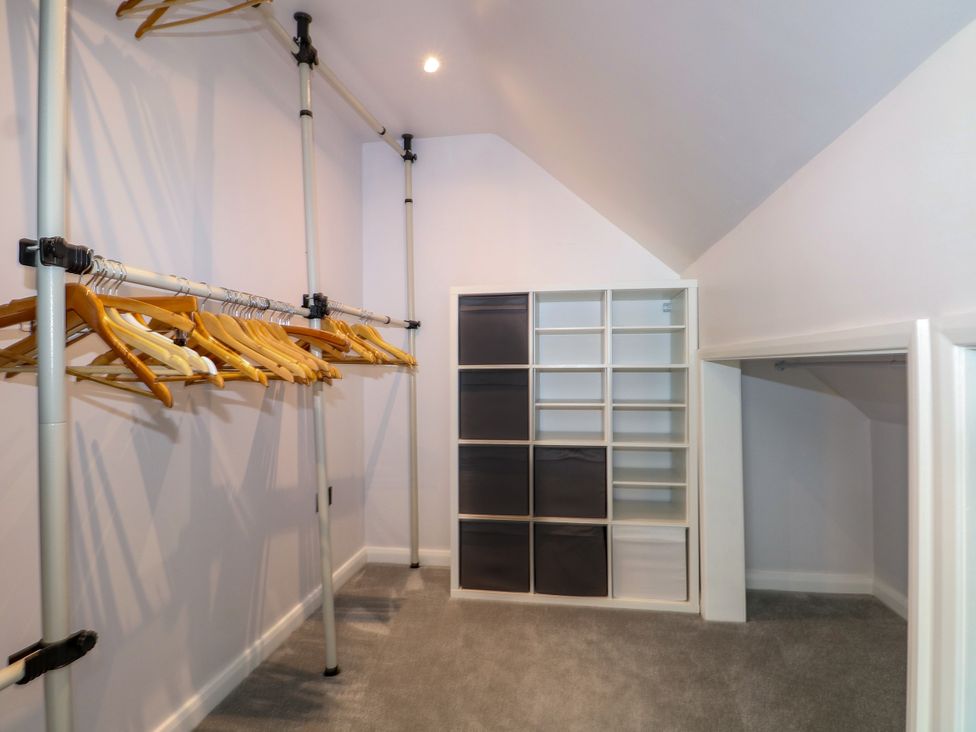 A closet with clothing rack and storage unit at Perry Dees in Minstead