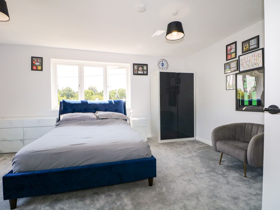 A bedroom with a bed and wardrobe at Perry Dees in Minstead