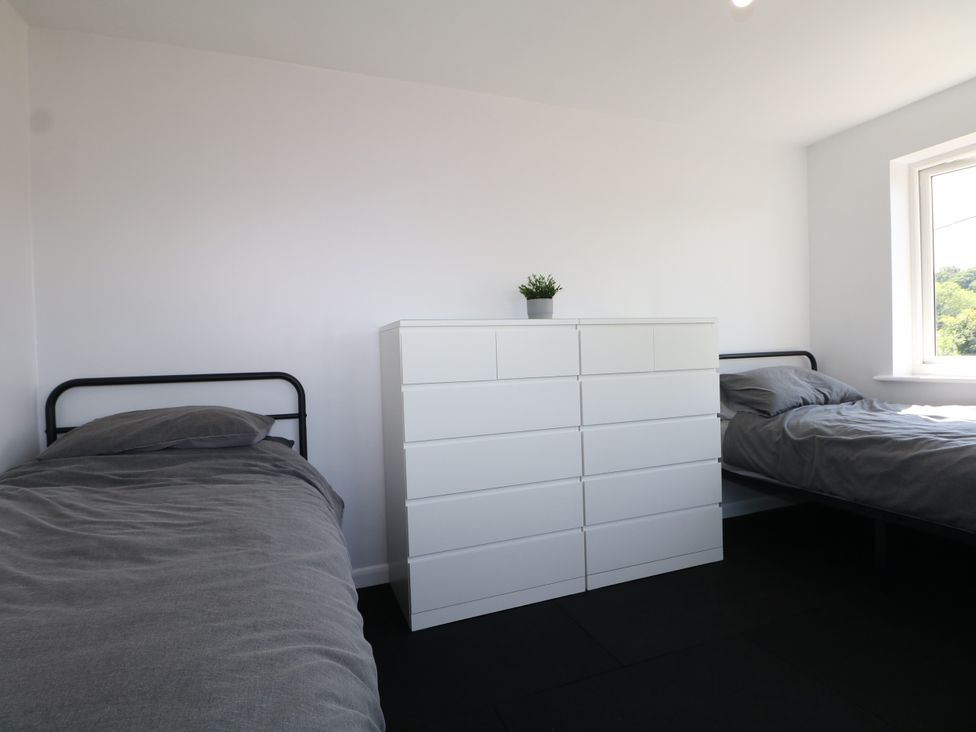 A bedroom with two beds and a dresser at Perry Dees in Minstead