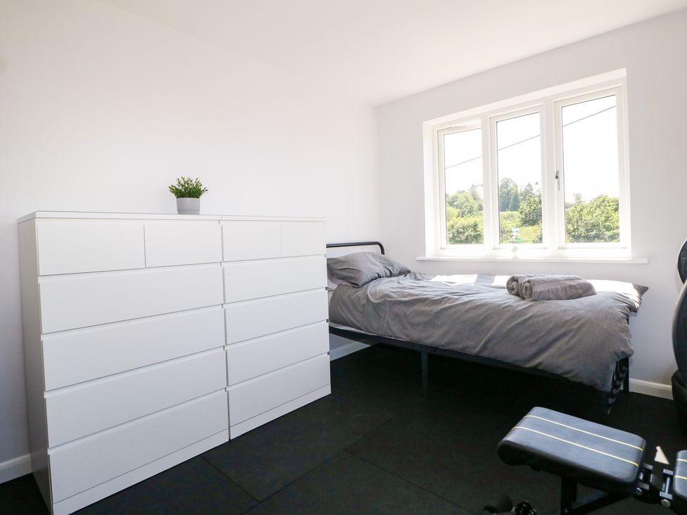 A bedroom with a bed and a chest of drawers at Perry Dees in Minstead