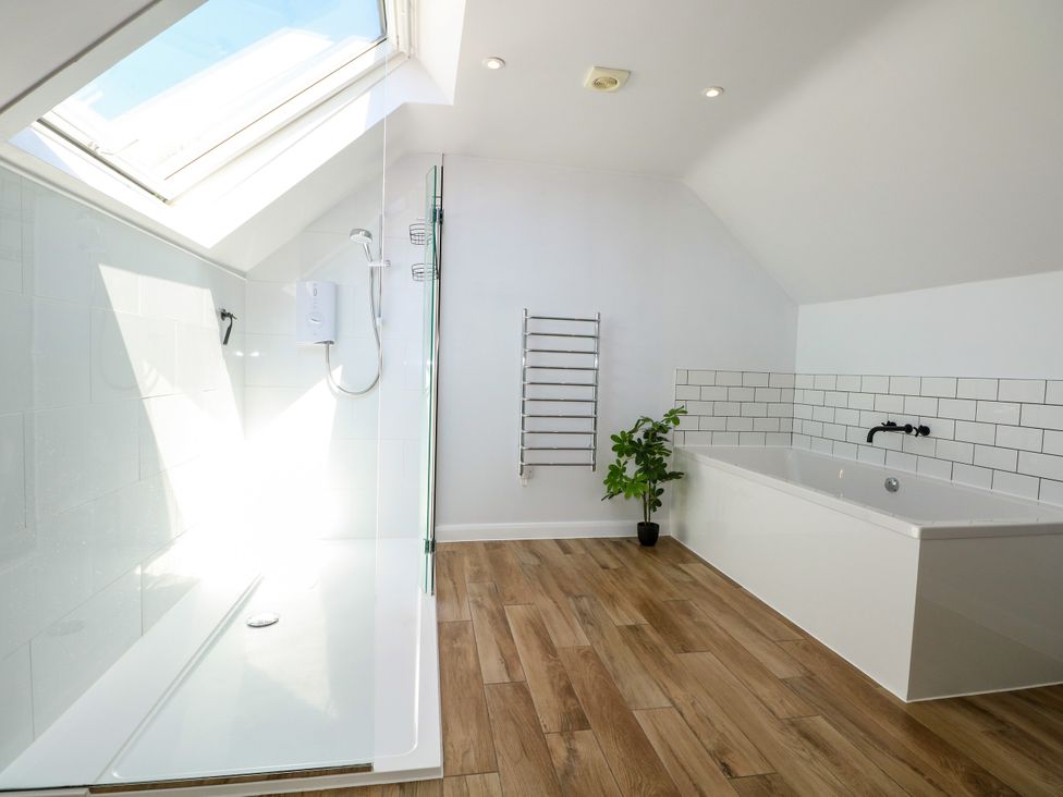 A bathroom with a shower and bathtub at Perry Dees in Minstead