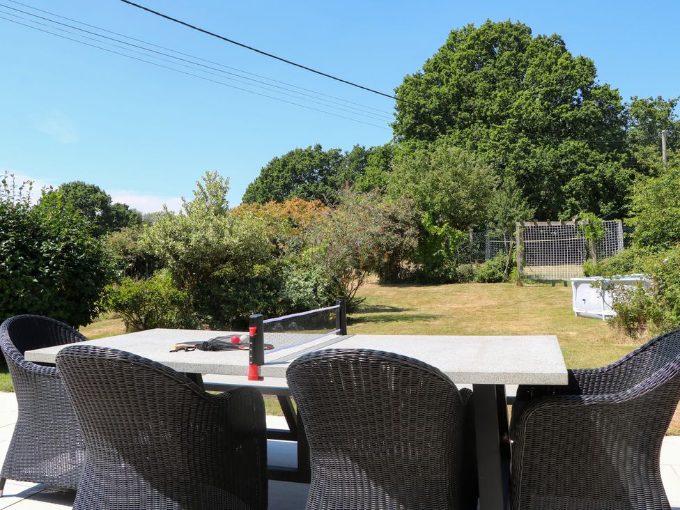 An outdoor dining setup with a table and chairs at Perry Dees in Minstead
