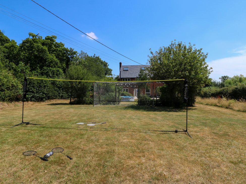 An outdoor area with a tennis net and equipment at Perry Dees in Minstead
