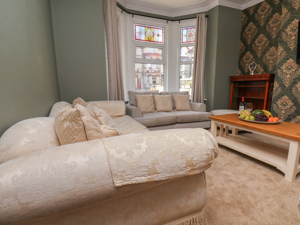 A living room with a couch, coffee table, and fruit bowl at Lansdowne Grange in Bridlington