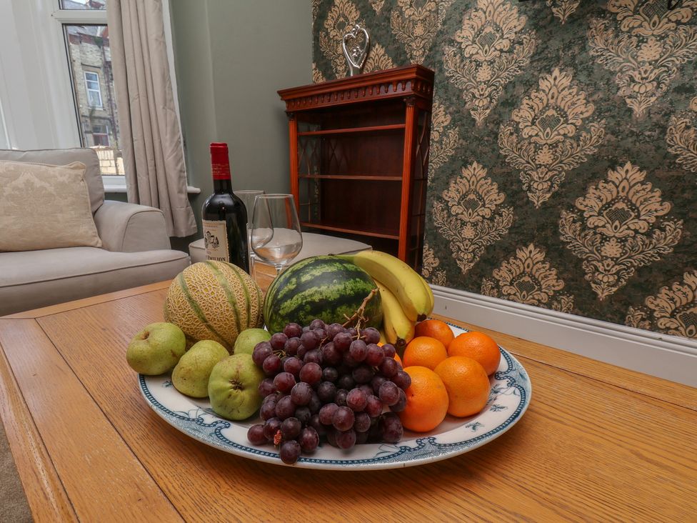 A living room with a fruit bowl on a table at Lansdowne Grange in Bridlington