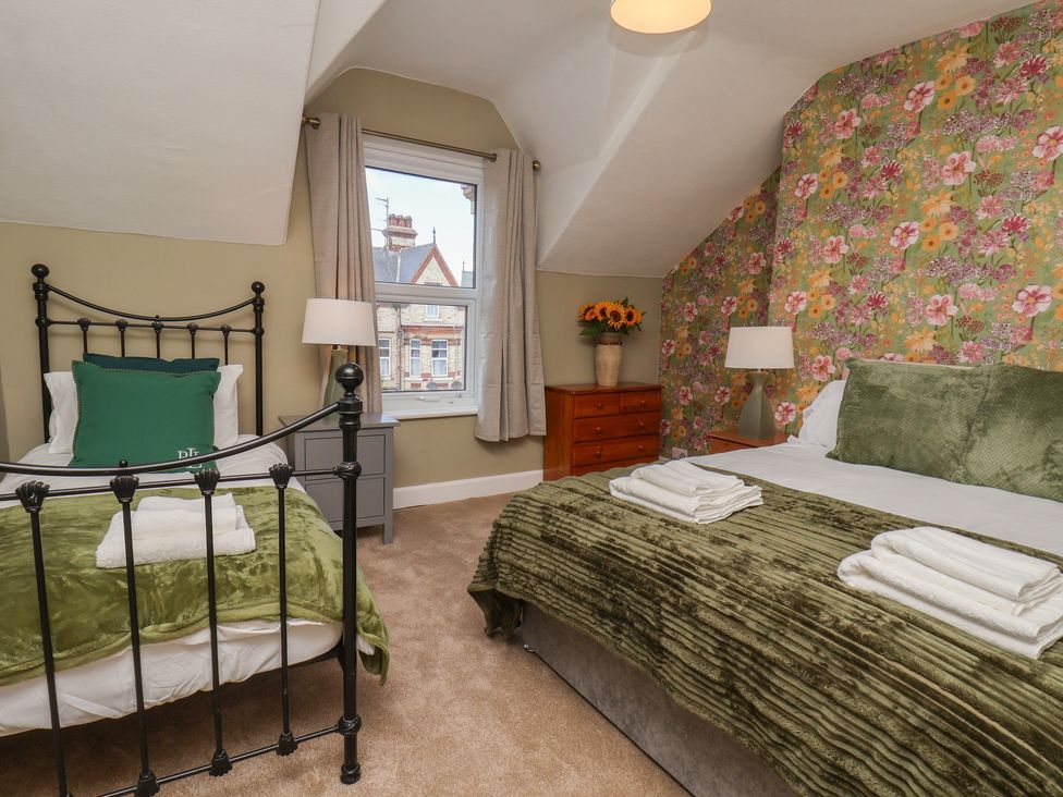 A bedroom with two beds and a window at Lansdowne Grange in Bridlington