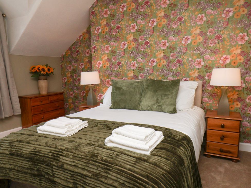 A bedroom with a bed and bedside tables at Lansdowne Grange in Bridlington