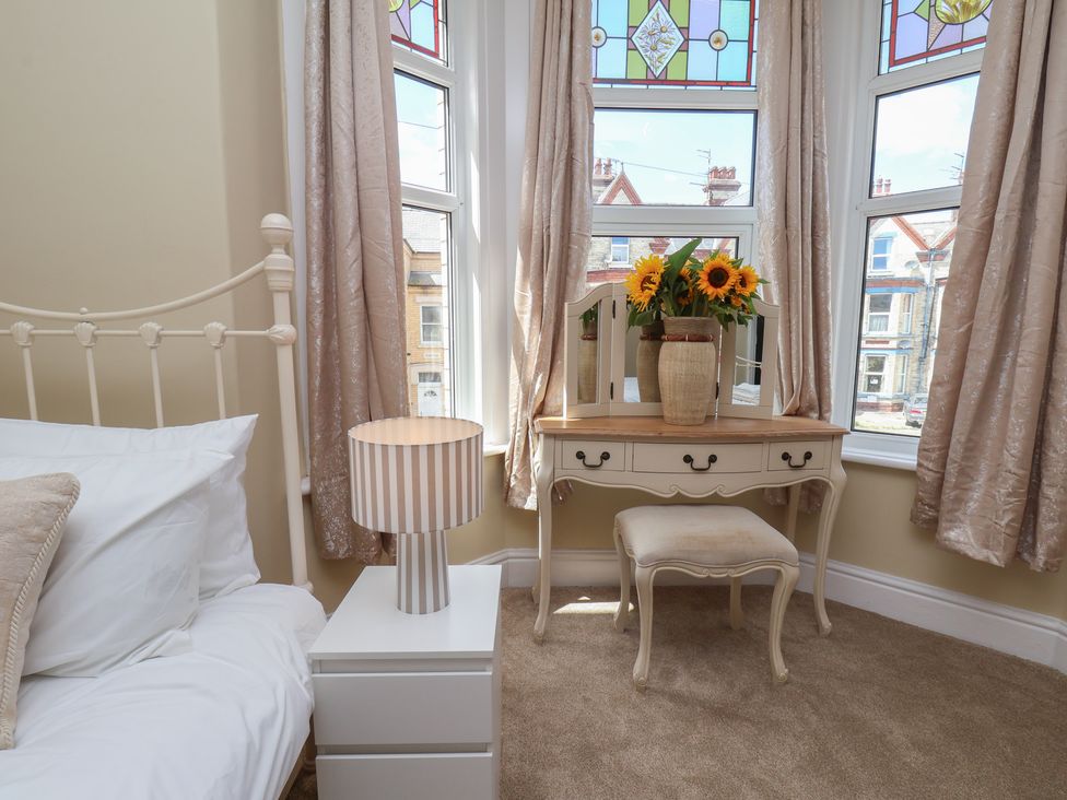 A bedroom with a bed and vanity table at Lansdowne Grange in Bridlington