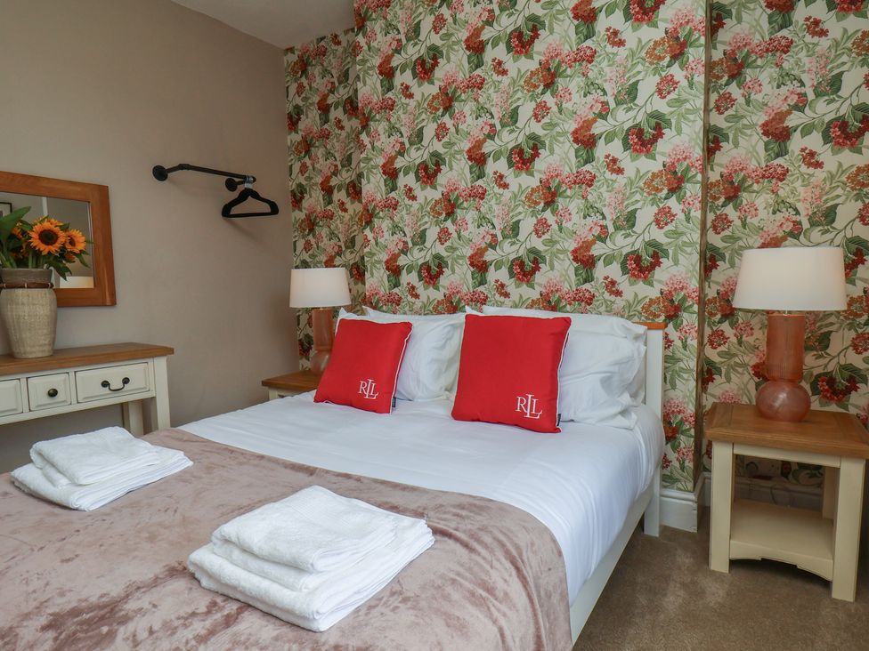 A bedroom with a bed and bedside tables at Lansdowne Grange in Bridlington