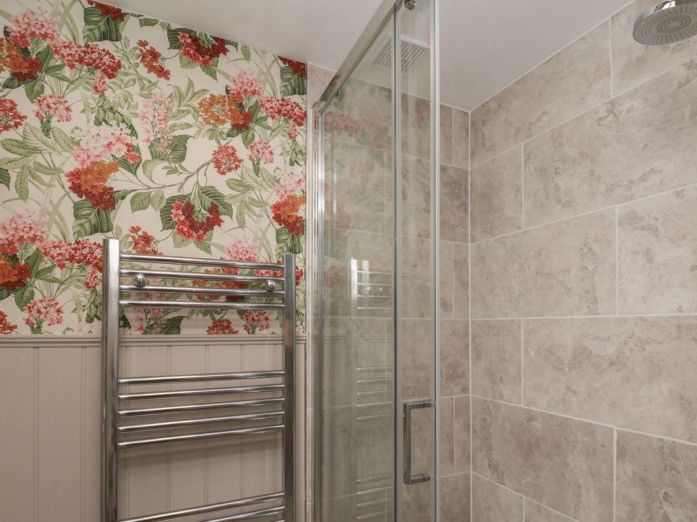 A bathroom featuring a shower and towel rail at Lansdowne Grange in Bridlington