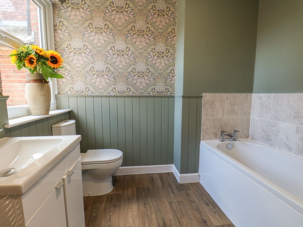 A bathroom with a bathtub and sink at Lansdowne Grange in Bridlington