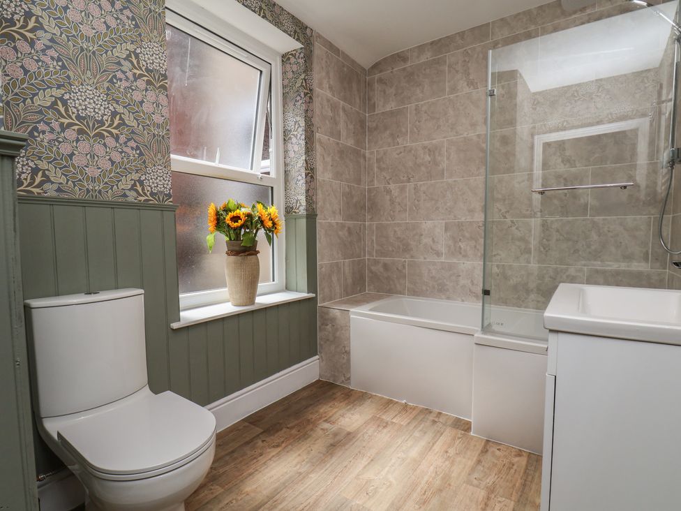A bathroom with a bathtub and sink at Lansdowne Grange in Bridlington