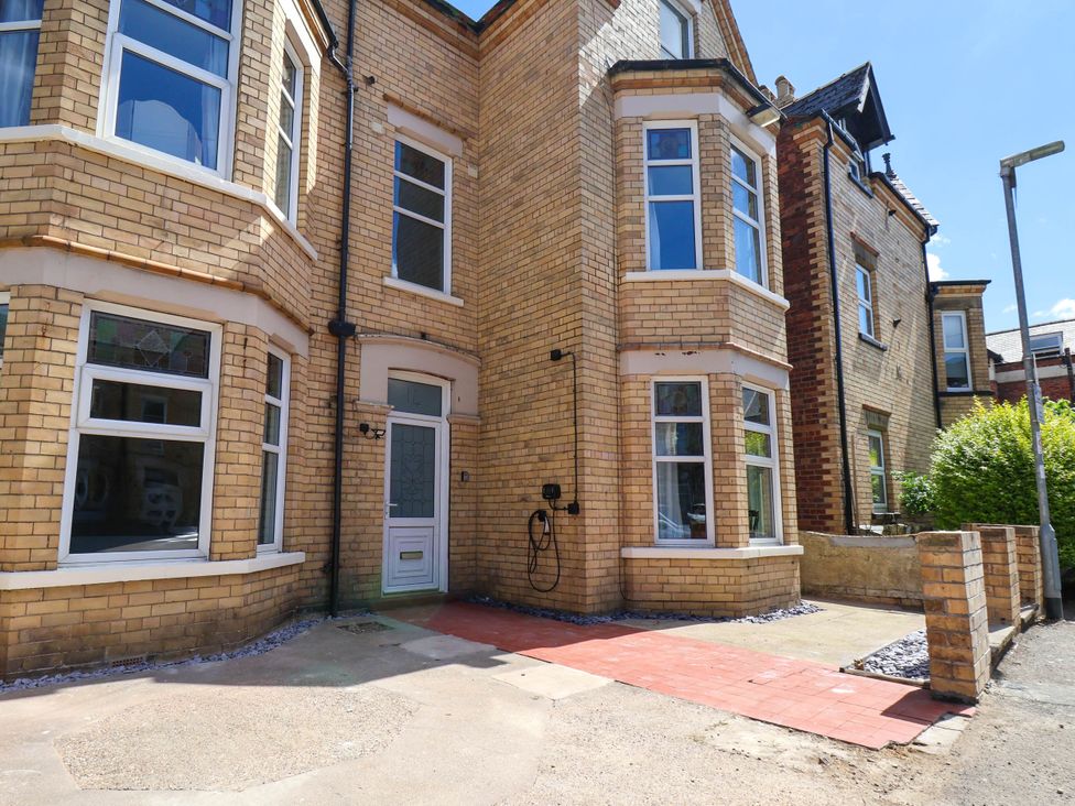 An exterior view of a house with windows and a pathway at Lansdowne Grange in Bridlington