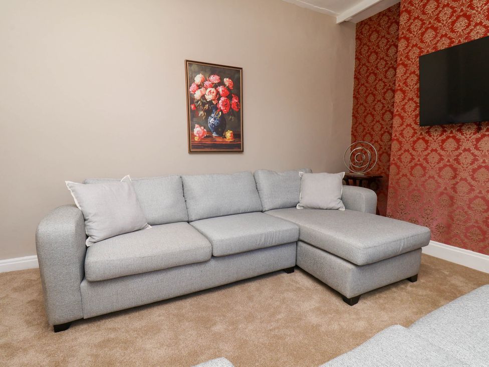 A living room with a sofa and a painting at Lansdowne Grange in Bridlington