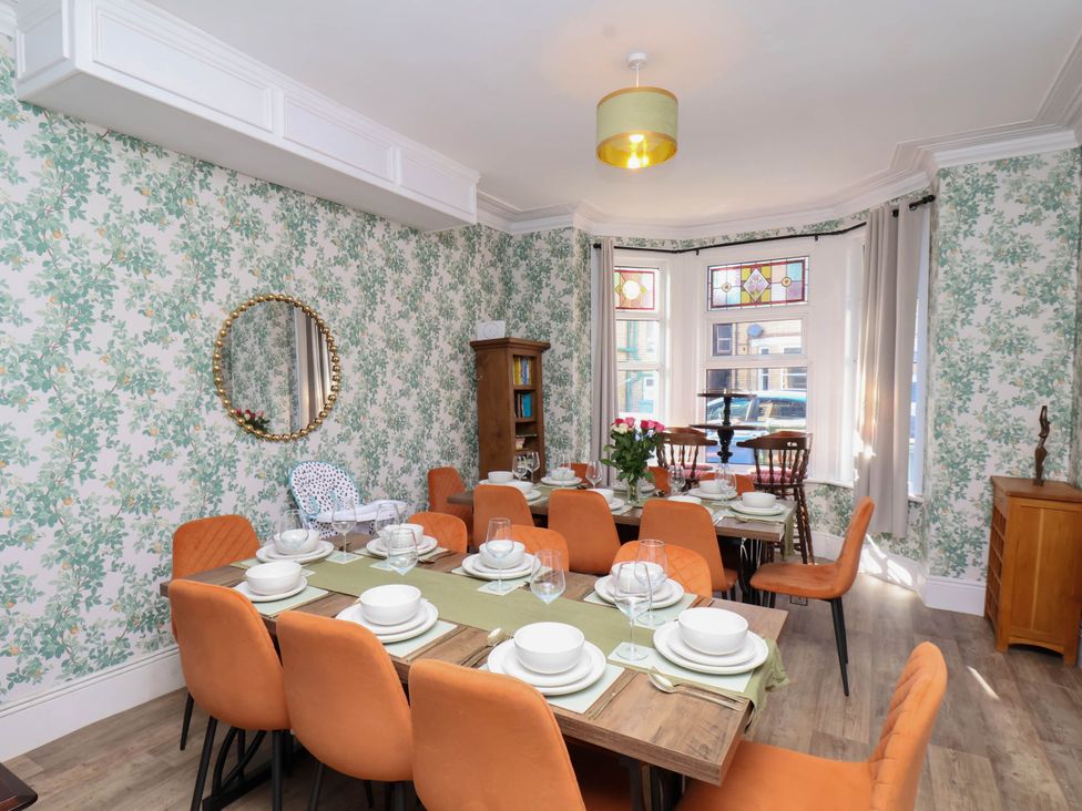 A dining room with a table set for meals at Lansdowne Grange in Bridlington