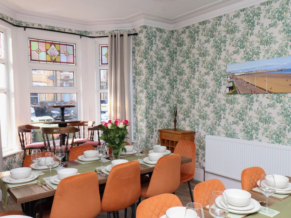 A dining room with a table set for dinner at Lansdowne Grange in Bridlington
