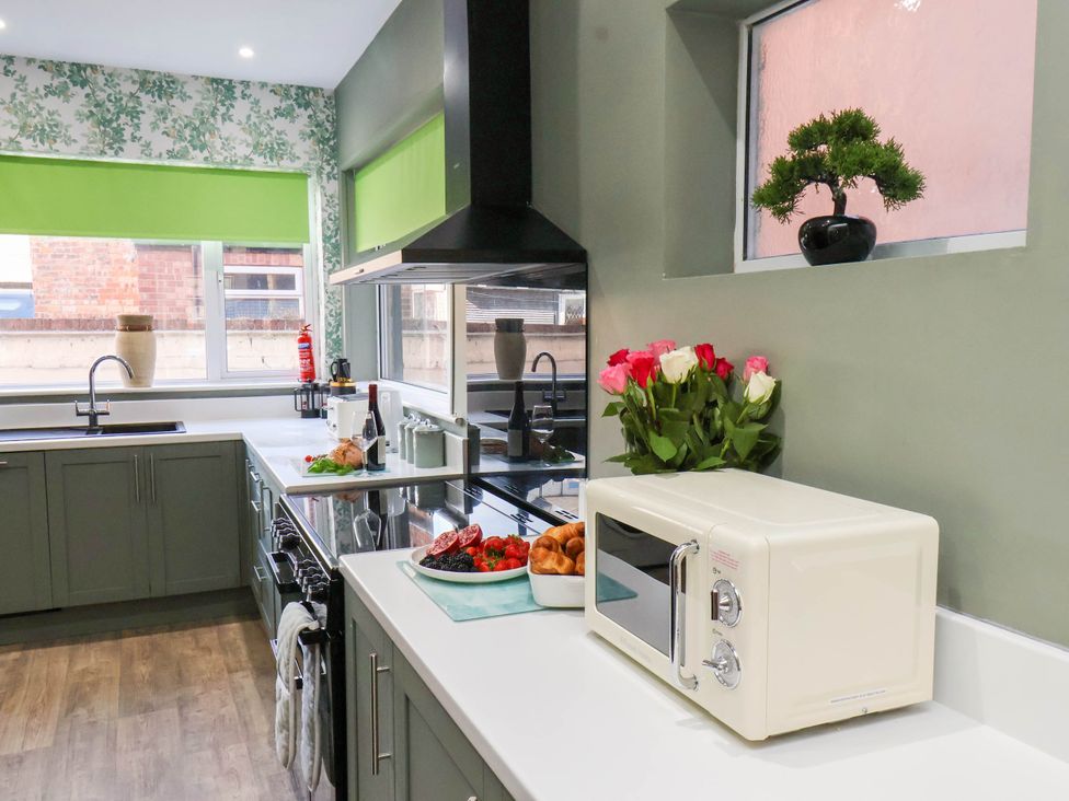A kitchen with a sink and microwave at Lansdowne Grange in Bridlington