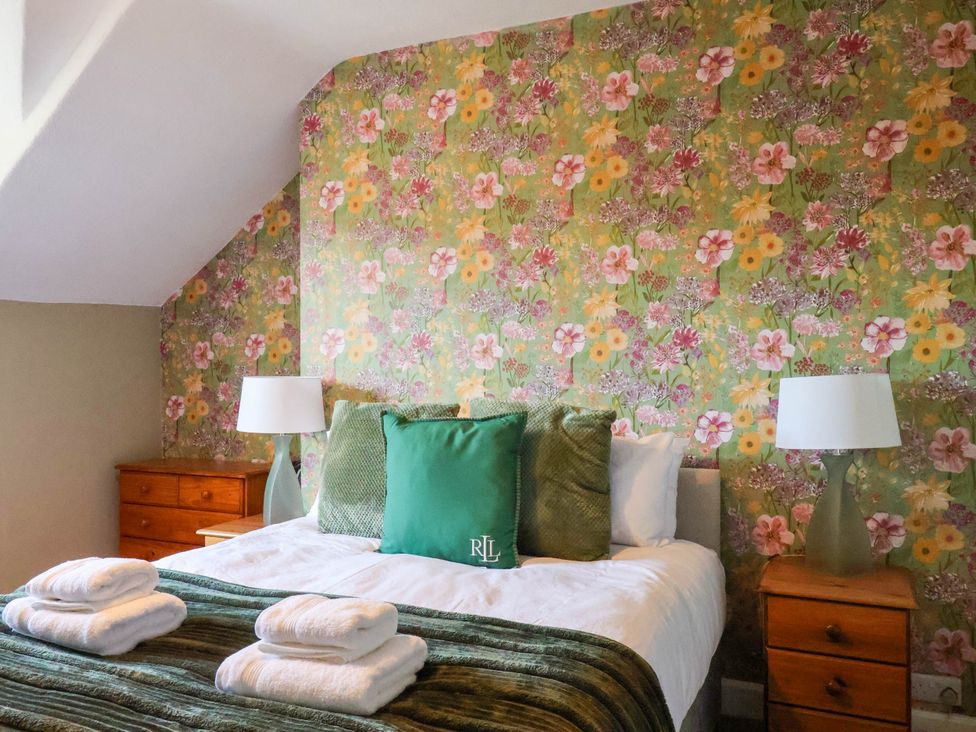 A bedroom with a bed and bedside tables at Lansdowne Grange in Bridlington