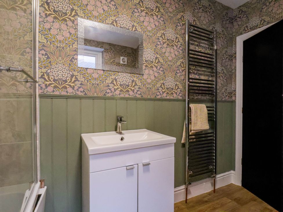 A bathroom with a sink and towel rail at Lansdowne Grange in Bridlington