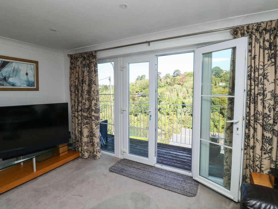 A living room with a television and sliding doors at 2 Inglewood Apartments, Dartmouth