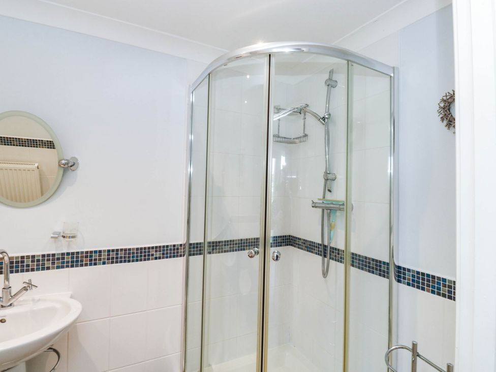 A bathroom with a shower and sink at 2 Inglewood Apartments in Dartmouth