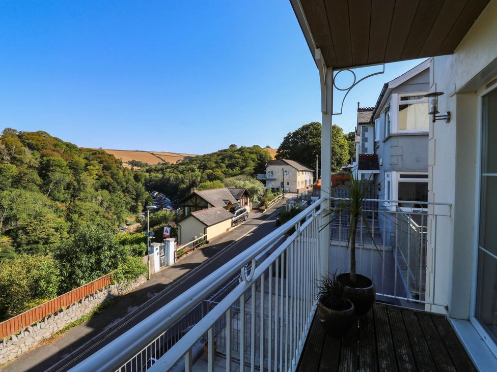 A balcony with a view of houses and trees at 2 Inglewood Apartments in Dartmouth