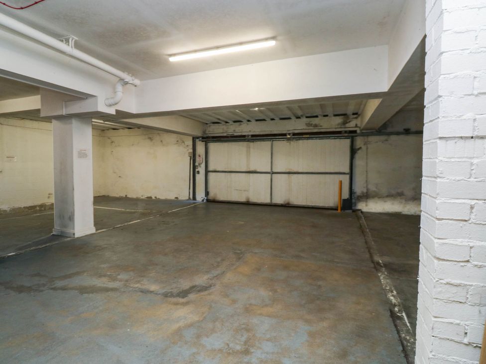 A garage with concrete floor and garage door at 2 Inglewood Apartments in Dartmouth