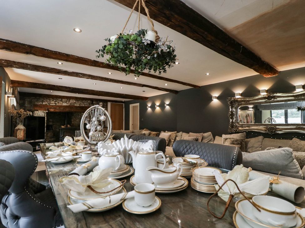 A dining room with a table set for tea at Llanfarach Farmhouse near Pontyclun