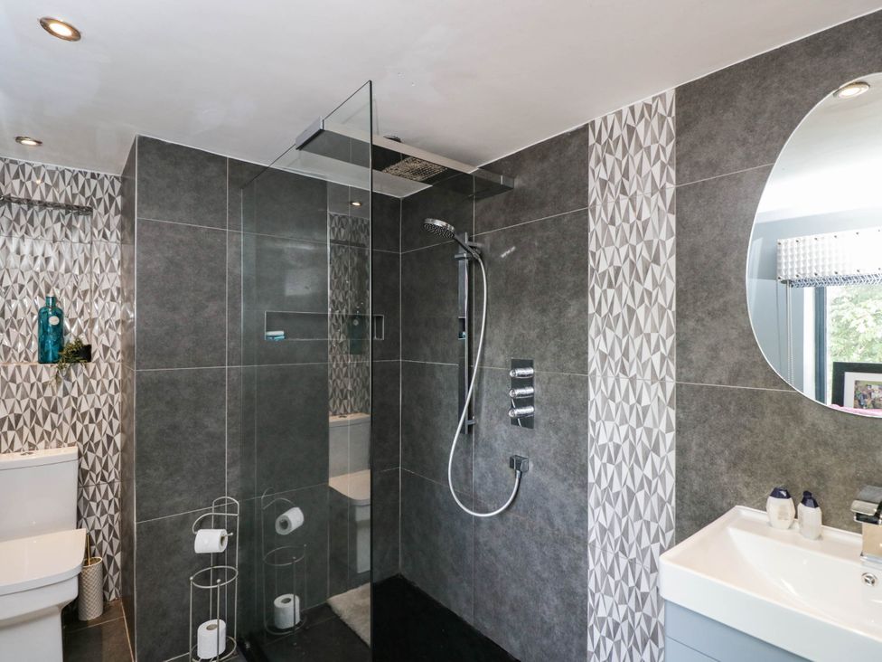 A bathroom with a shower and toilet at Llanfarach Farmhouse near Pontyclun