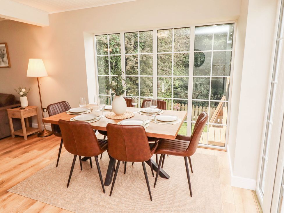 A dining room with a table set for dinner at Hedley Dene Cottage in Longhorsley