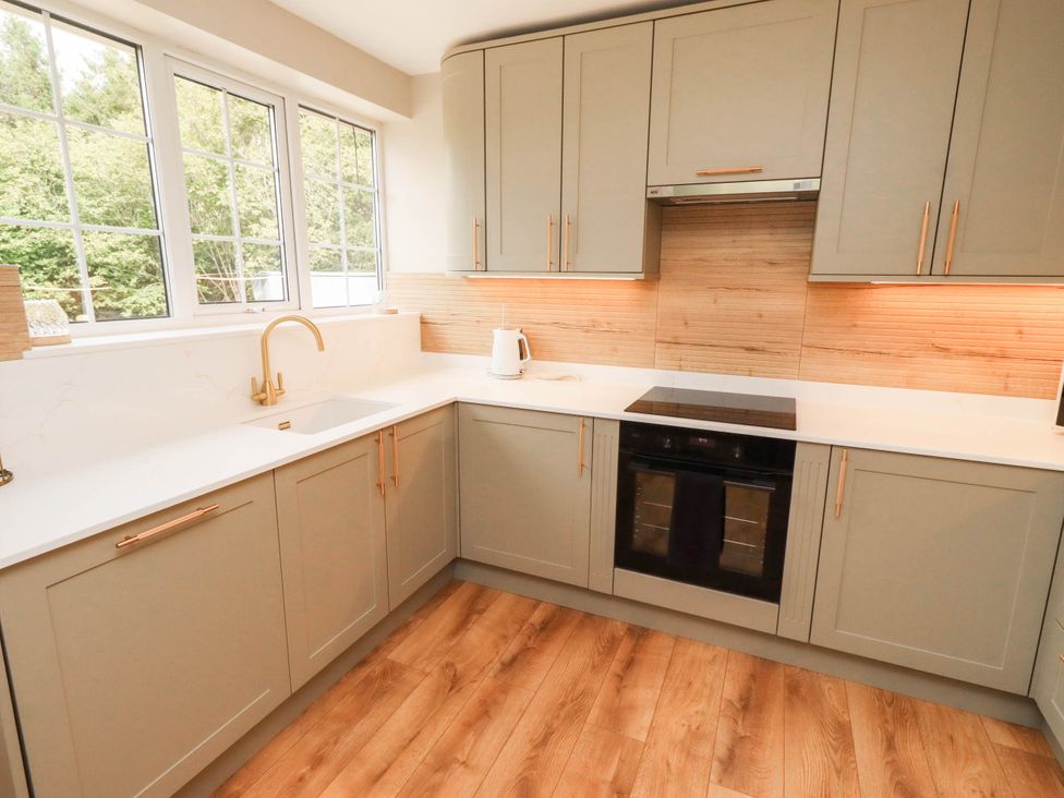 A kitchen with sink and oven at Hedley Dene Cottage in Longhorsley
