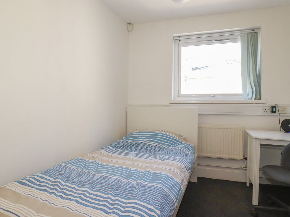 A bedroom with a bed and a desk at Newseal House