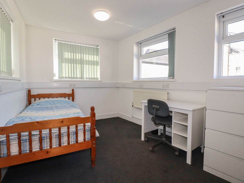 A bedroom with a bed and desk at Newseal House