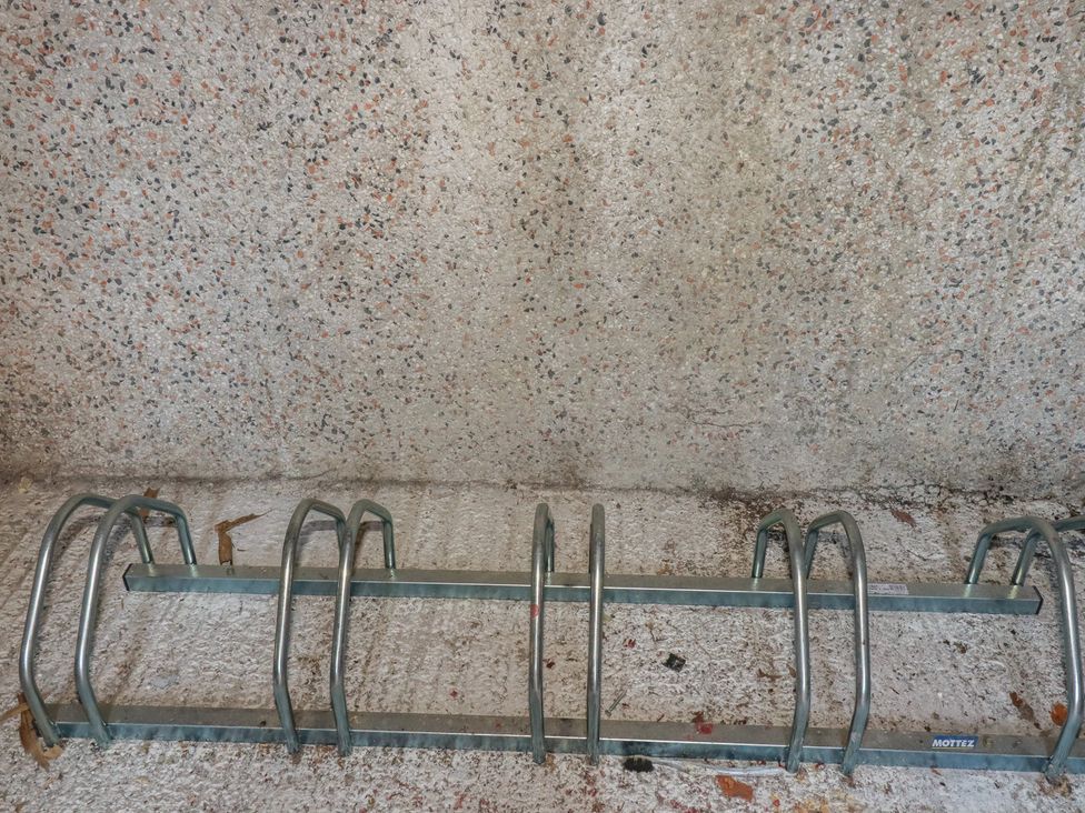 A bicycle rack mounted against a wall at Newseal House