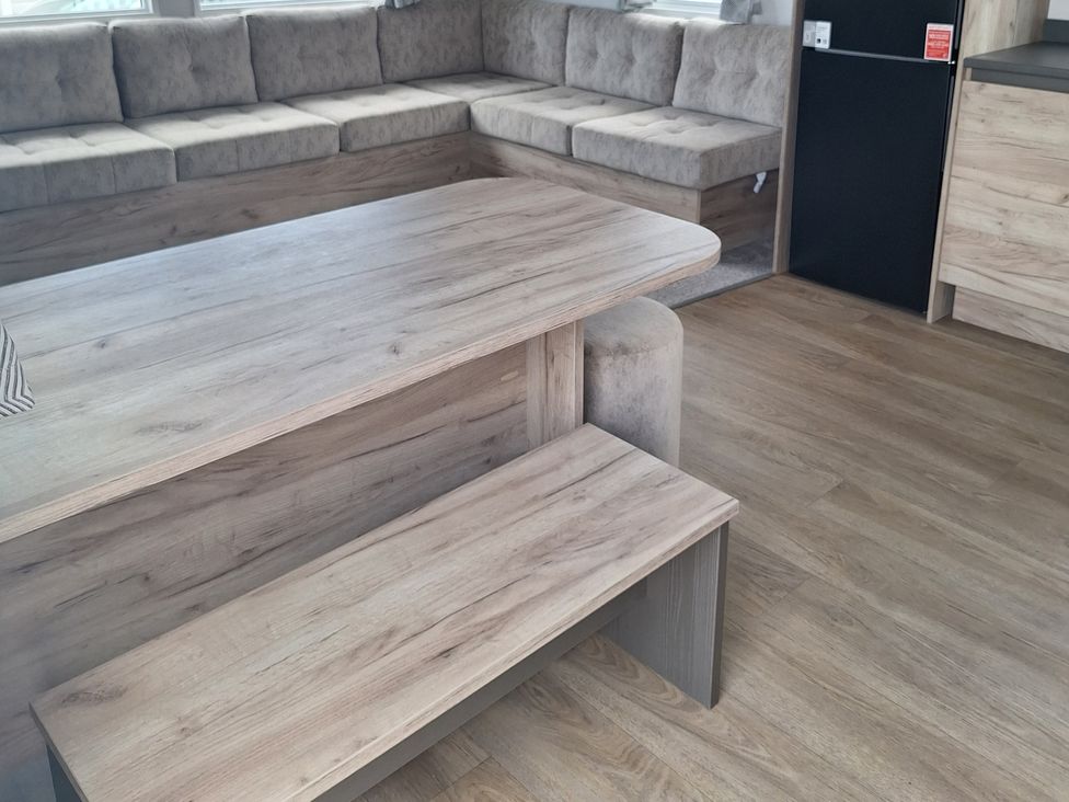 A living room with a sofa and a dining table at Haven Seashore, Ellerton Willerby Xtra, Great Yarmouth