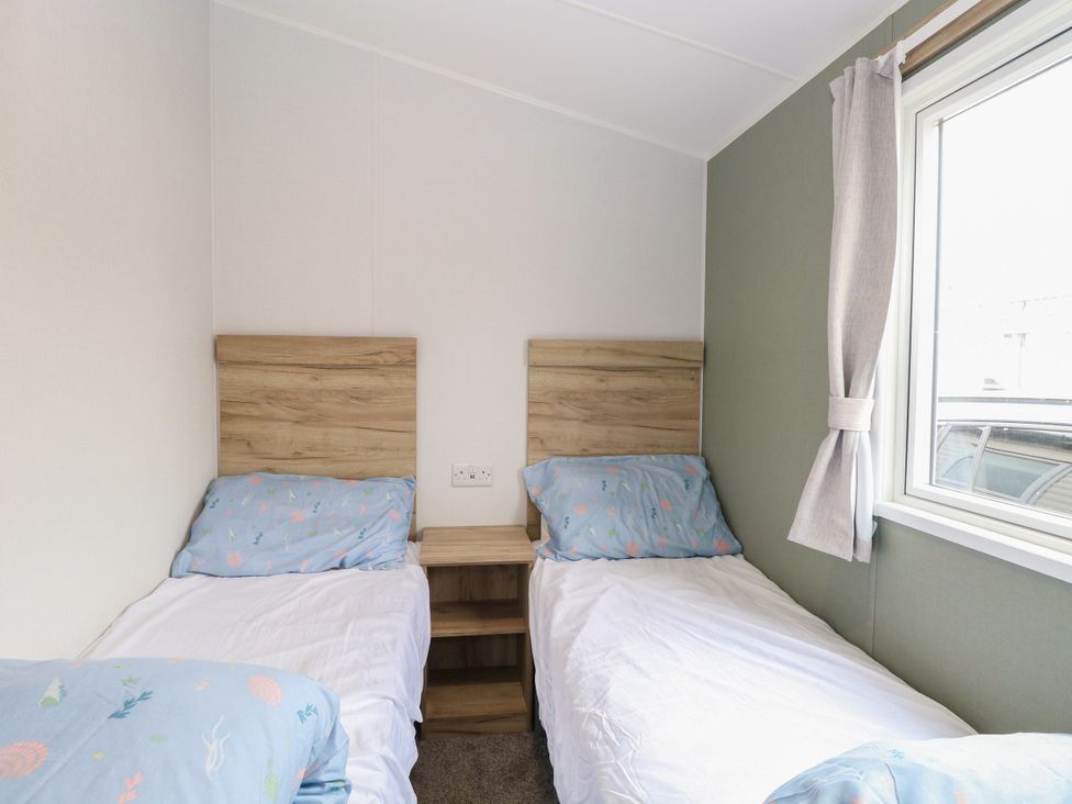 A bedroom with two beds and a window at Haven Seashore, Ellerton Willerby Xtra, Great Yarmouth