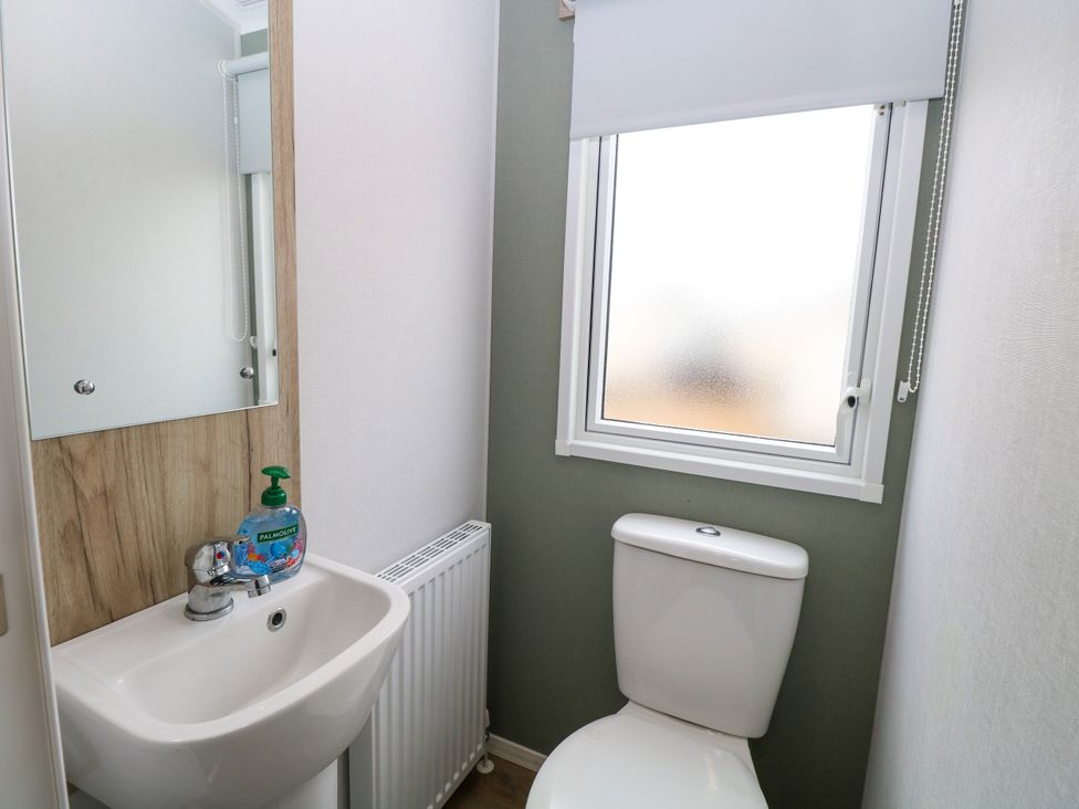 A bathroom with a sink and a toilet at Haven Seashore, Ellerton Willerby Xtra in Great Yarmouth