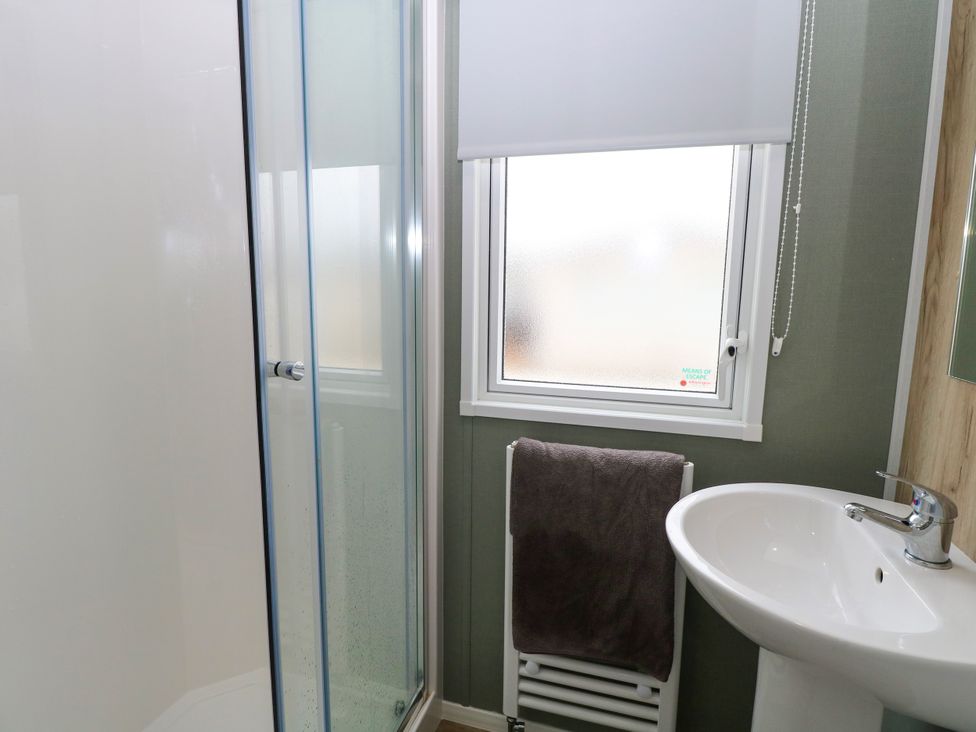 A bathroom with a shower and sink at Haven Seashore, Ellerton Willerby Xtra, Great Yarmouth