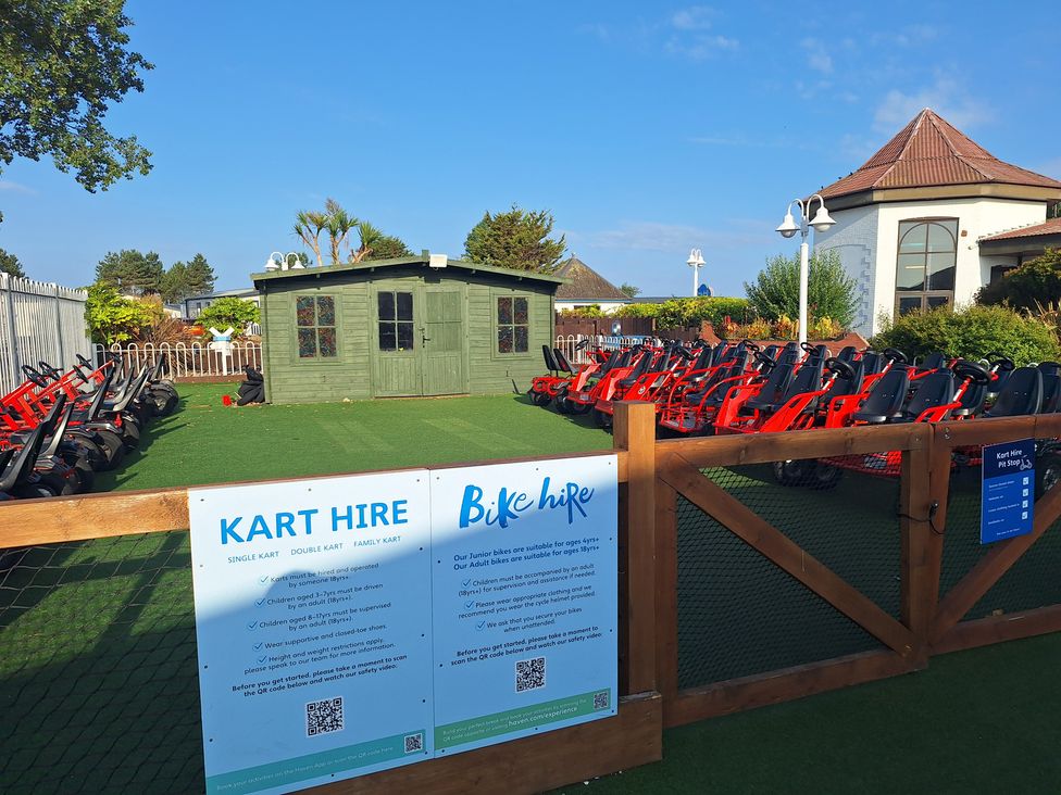 An outdoor kart hire area with go-karts and a shed at Haven Seashore, Ellerton Willerby Xtra, Great Yarmouth