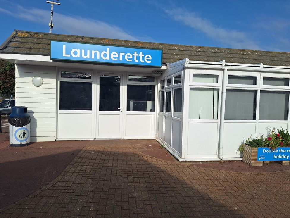 An outdoor launderette with windows and a door at Haven Seashore, Ellerton Willerby Xtra, Great Yarmouth