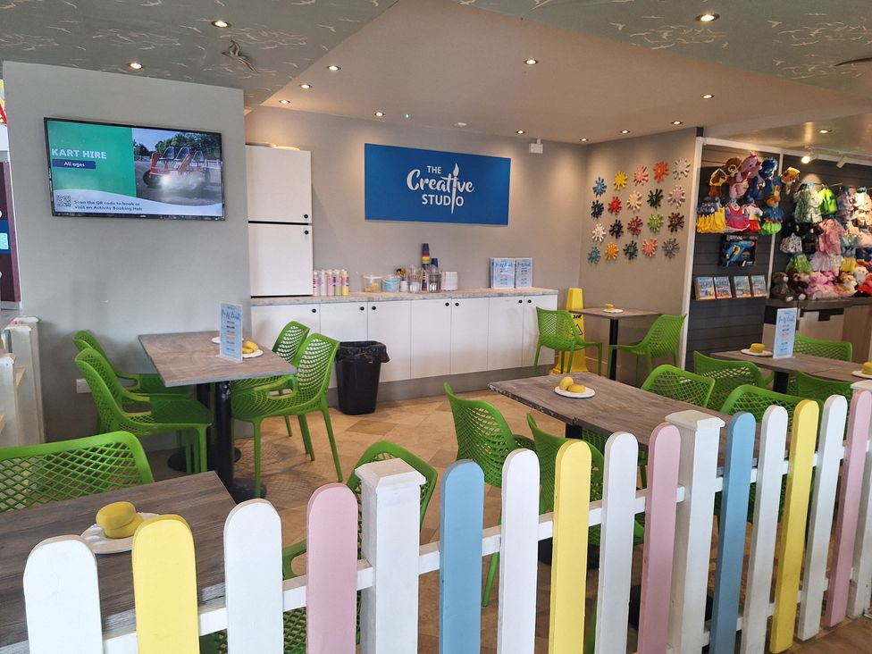 A creative studio with tables and green chairs at Haven Seashore, Ellerton Willerby Xtra, Great Yarmouth